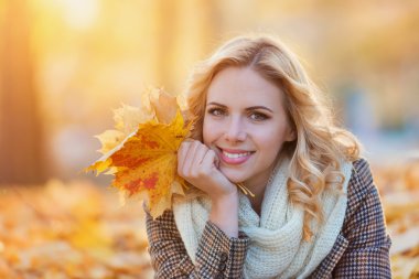 Ekose desenli ceket sonbahar parkta oturan kadın