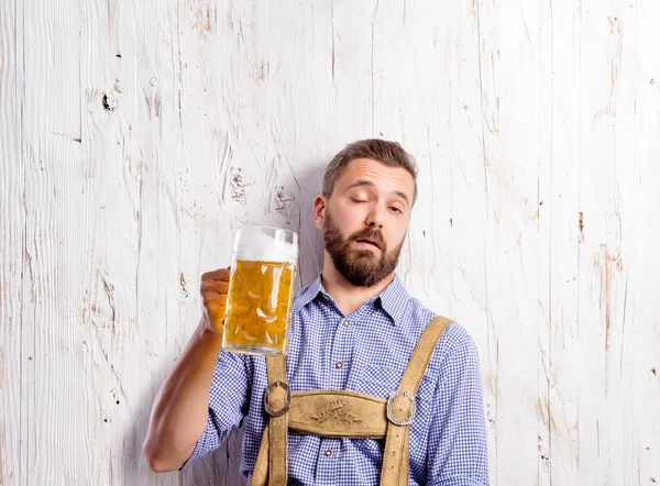 Drunk man in bavarian clothes with beer — Stock Photo, Image