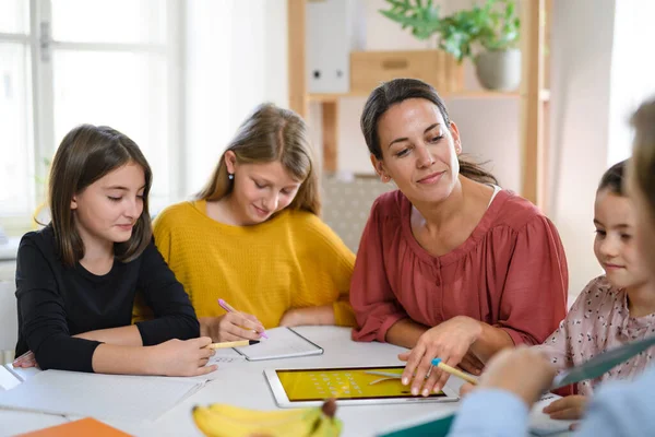 Otthonról tanuló gyerekek csoportja tanárokkal, akik házon belül tanulnak, a koronavírus fogalma. — Stock Fotó