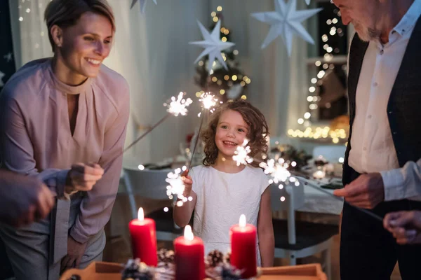 Small girl with parents and grandparents indoors celebrating Christmas. — Stock Photo, Image