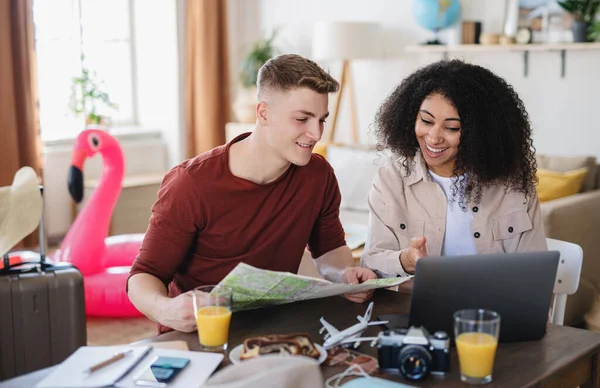 Casal jovem com embalagem de laptop para férias, conceito de coronavírus. — Fotografia de Stock