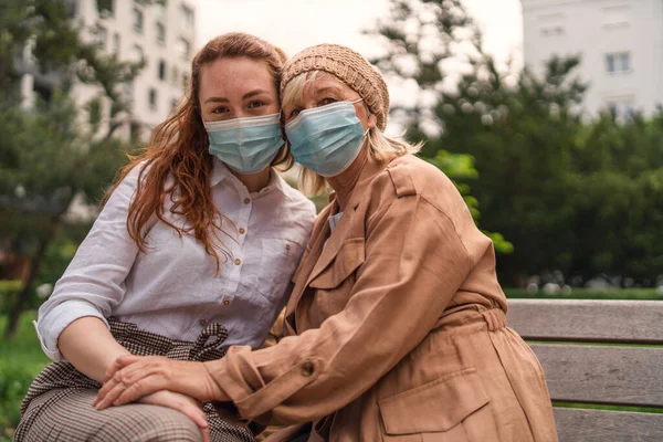 Retrato de mulher jovem com avó ao ar livre na cidade, vida após a vacinação covid-19. — Fotografia de Stock