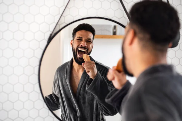 Young man having fun indoors at home, morning or evening routine concept. — Stock Photo, Image
