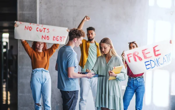 Estudantes universitários ativistas protestando dentro de casa, lutando pelo conceito de educação gratuita. — Fotografia de Stock