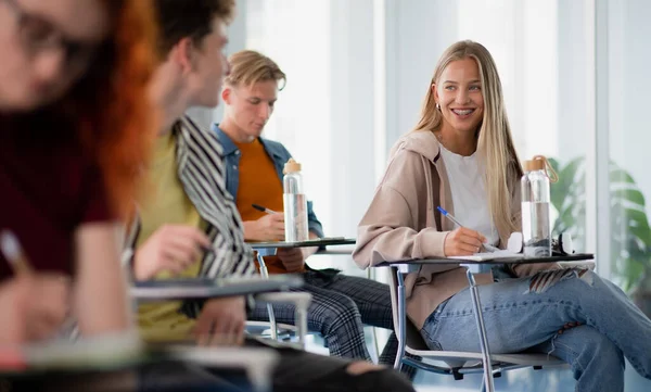 Portrait of group of university students sitting in classroom indoors, studying. — Stock Photo, Image