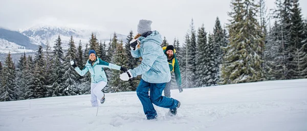 Family with small daughter having fun outdoors in winter nature, Tatra mountains Slovakia. — Stock Photo, Image