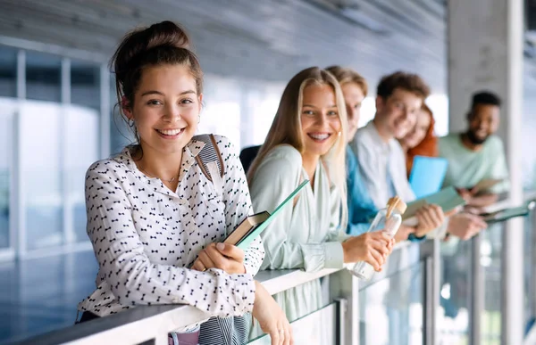 Universitetsstudenter som står och tittar på kameran inomhus, tillbaka till skolkonceptet. — Stockfoto