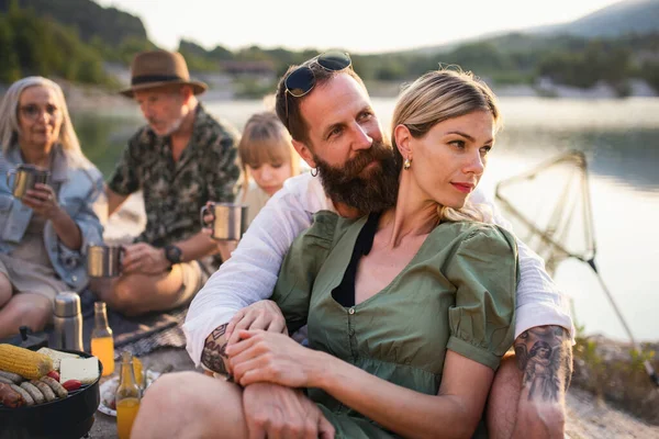 Bonne famille multigénération en voyage de vacances d'été, barbecue au bord du lac. — Photo