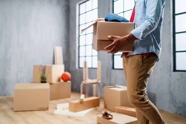 Unrecognizable young man with packing boxes moving home, new living concept. — Stock Photo, Image