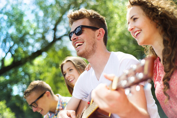 Friends with guitar having fun