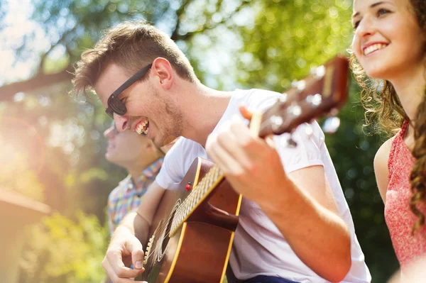 Friends with guitar having fun