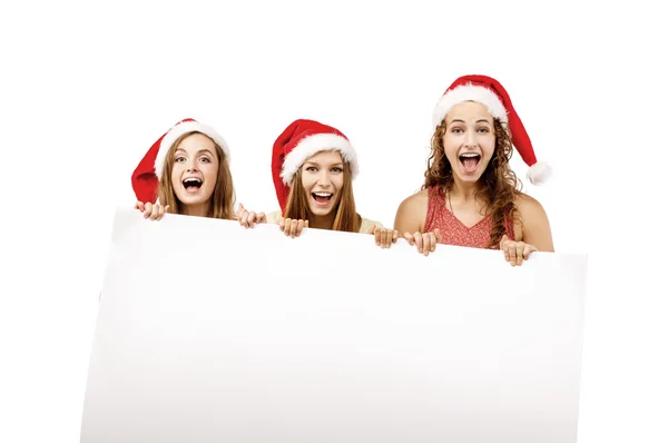 Chicas en sombreros de Navidad con pancarta en blanco —  Fotos de Stock