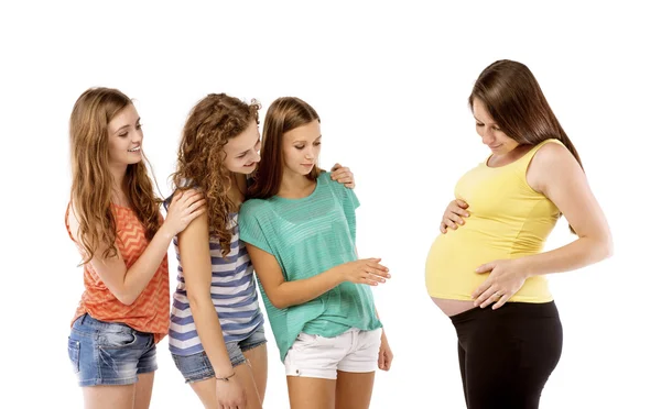 Girls touching pregnant woman's belly — Stock Photo, Image