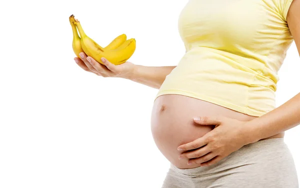 Mulher grávida segurando bananas — Fotografia de Stock