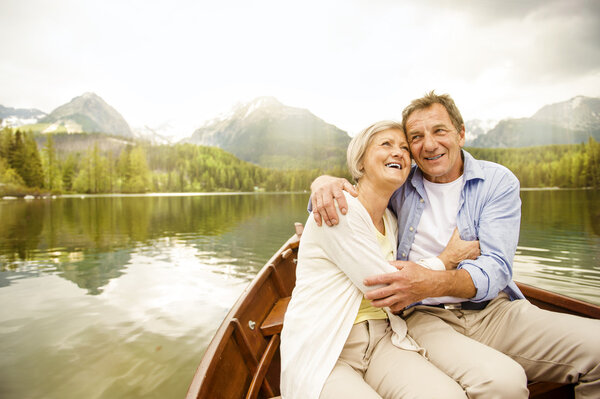 Senior couple hugging on boat