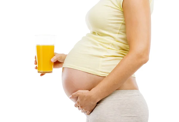 Pregnant woman holding orange juice Stock Photo