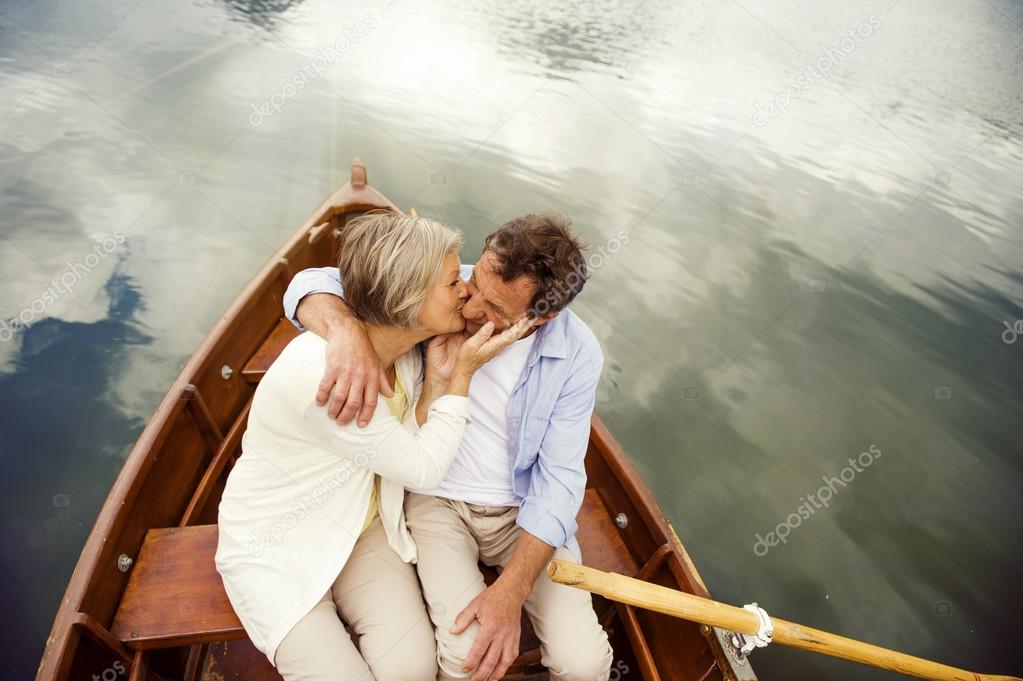 Senior couple kissing on boat