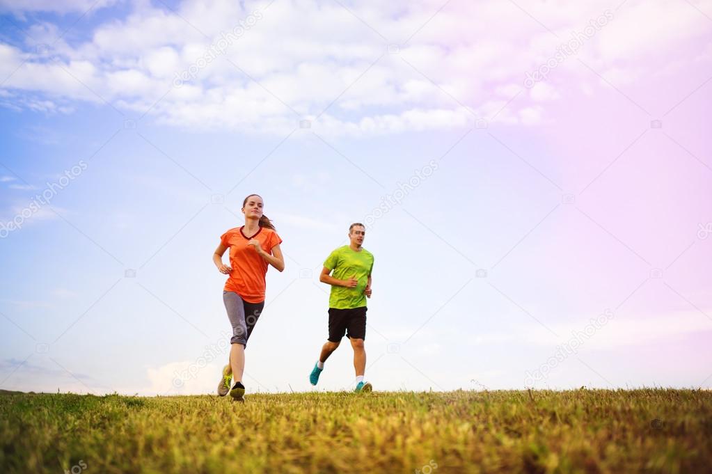 Runner couple exercising at sunset.