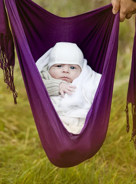 Boy hanging in a baby sling — Stock Photo, Image