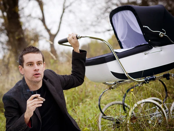 Father with baby in vintage pram — Stock Photo, Image