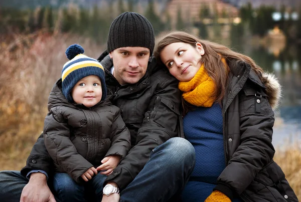 Familie zittend op de pier — Stockfoto