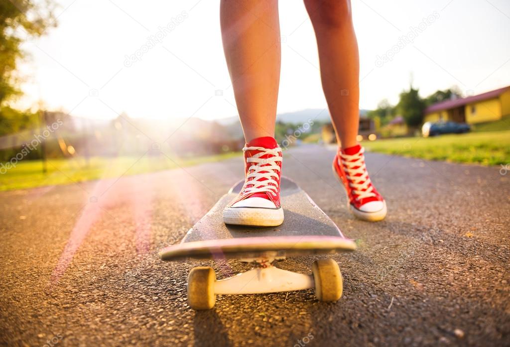 Skater girl's feet and skateboard ⬇ Stock Photo, Image by © halfpoint