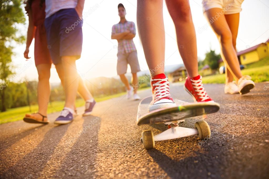 Legs of young people on skateboard