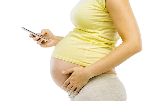 Těhotná žena pomocí mobilního telefonu — Stock fotografie
