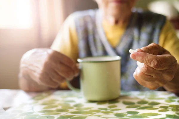 Old woman is taking pills — Stock Photo, Image