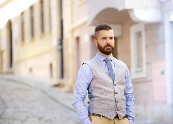 Businessman with beard walking in town — Stock Photo, Image