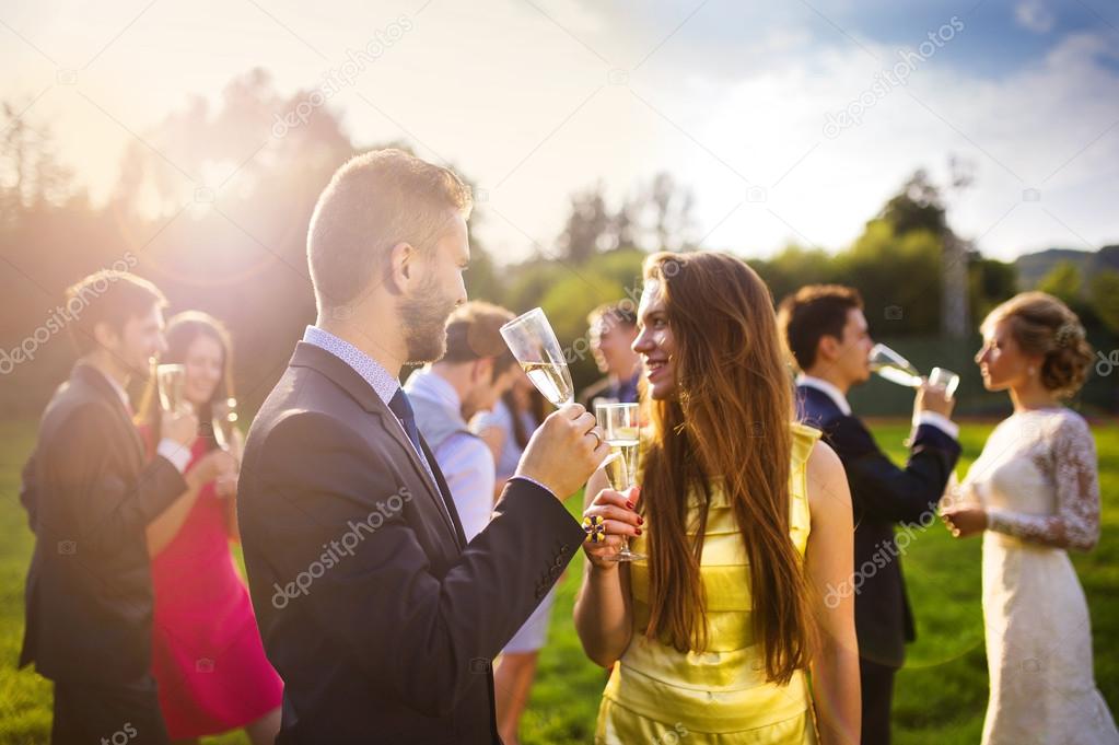 Wedding guests clinking glasses