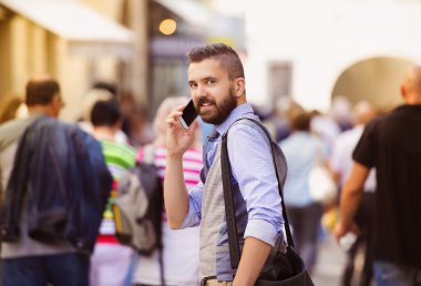 Şehirdeki cep telefonu konuşurken işadamı