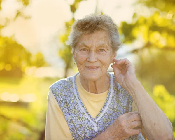 Woman in apron in garden — Stock Photo, Image