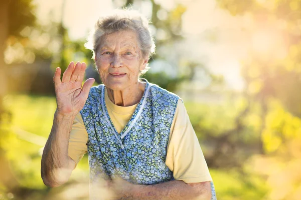 Woman in apron in  garden — Stock Photo, Image