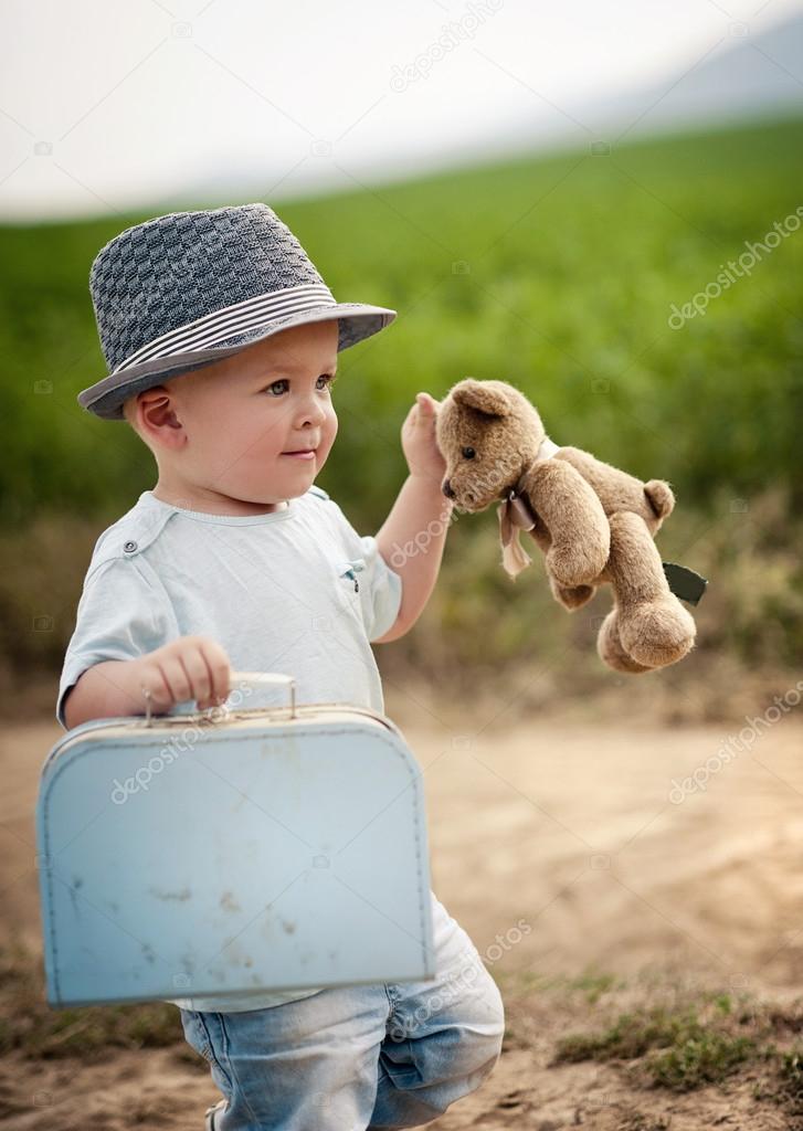 Little boy playing with teddy bear