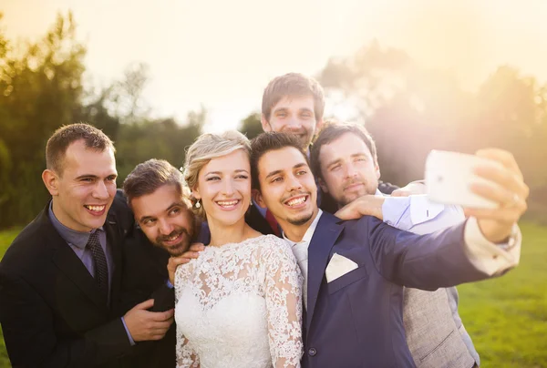 Bride, groom and his friends taking selfie — Stock Photo, Image