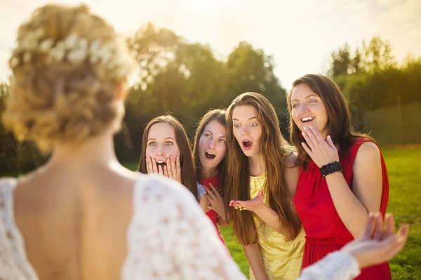Surprised bridesmaids looking at bride — Stock Photo, Image