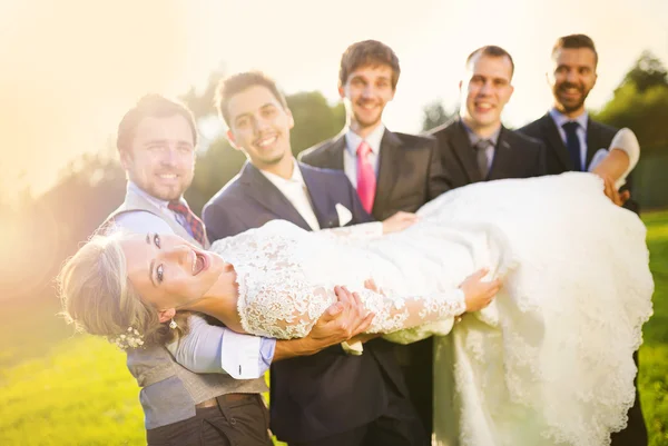 Sposo con i suoi amici tenendo sposa — Foto Stock