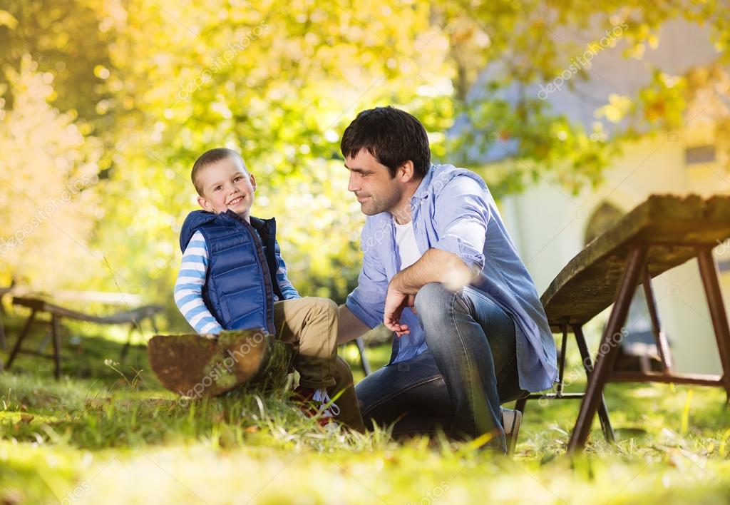 Little Boy Is Tying His Father S Shoes Stock Photo C Halfpoint 55510859