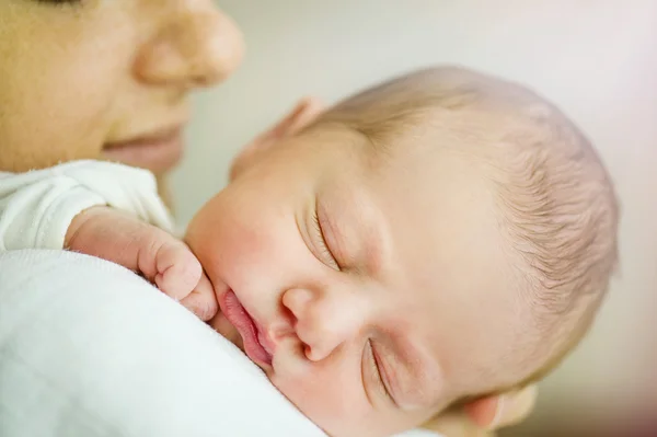 Mother is holding her newborn baby girl — Stock Photo, Image