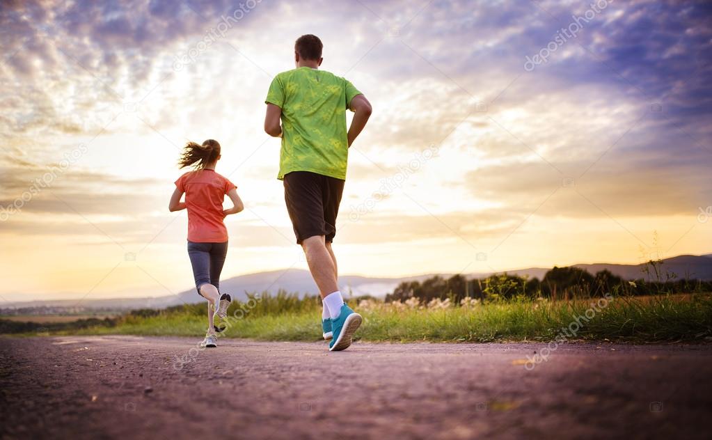 Cross-country trail running people at sunset