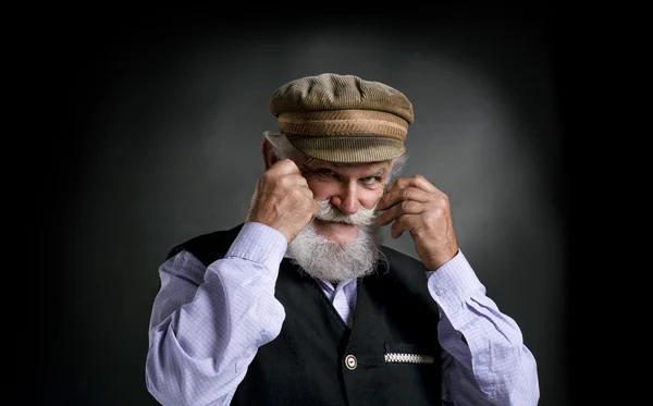 Bearded man holding his moustache — Stock Photo, Image