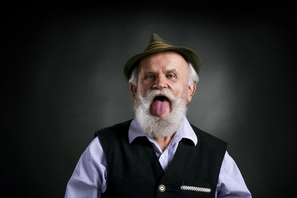 Bavarian man sticking his tongue out — Stock Photo, Image