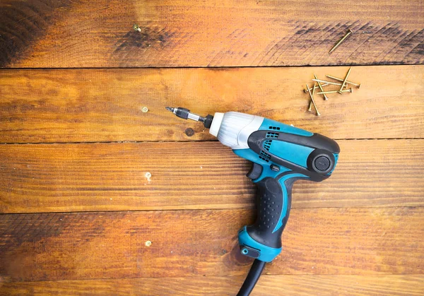 Electric drill and nail left — Stock Photo, Image