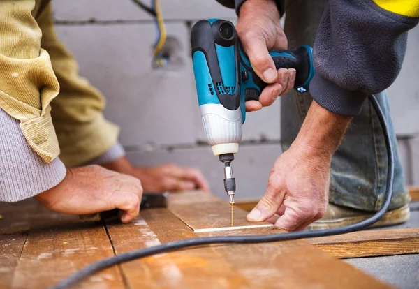 Handymen installing flooring in patio — Stock Photo, Image