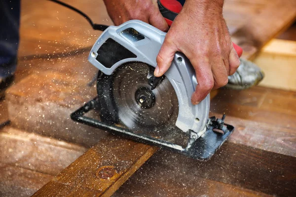 Hands grinding wooden planks — Stock Photo, Image