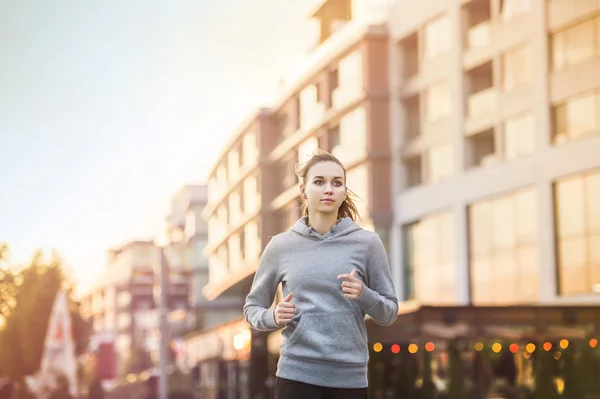 Female runner is jogging in the street — Stock Photo, Image