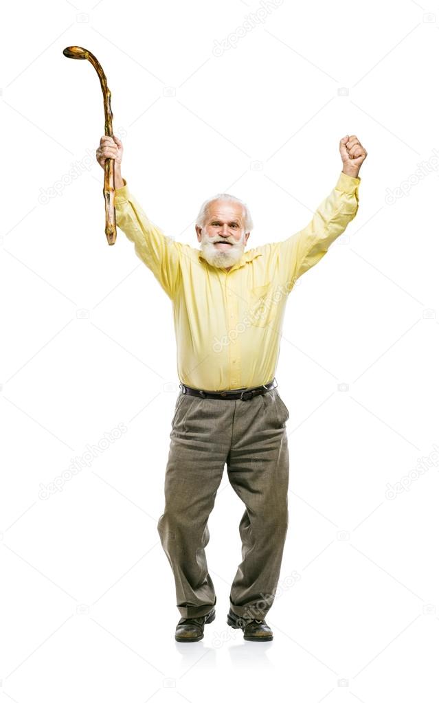 Bearded man jumping with cane in his hand