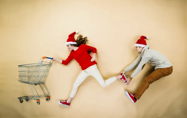 Christmas couple with trolley — Stock Photo, Image