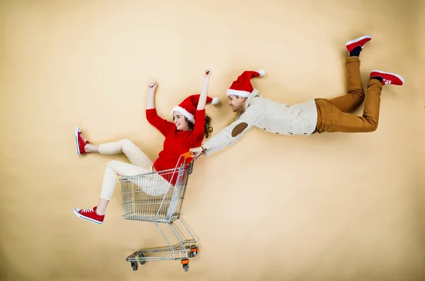 Christmas couple with trolley — Stock Photo, Image